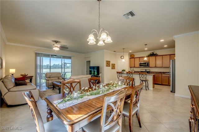 dining room with light tile patterned floors, visible vents, crown molding, and ceiling fan with notable chandelier