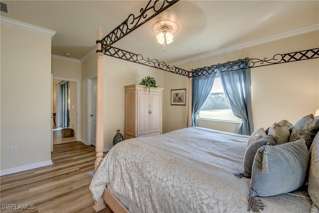 bedroom with visible vents, ornamental molding, light wood-style flooring, and baseboards