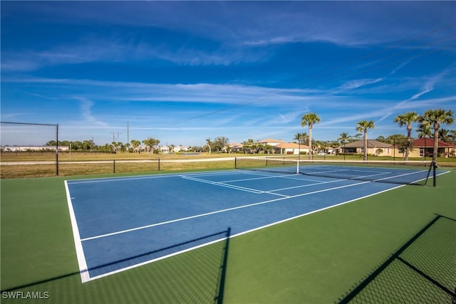 view of sport court featuring fence