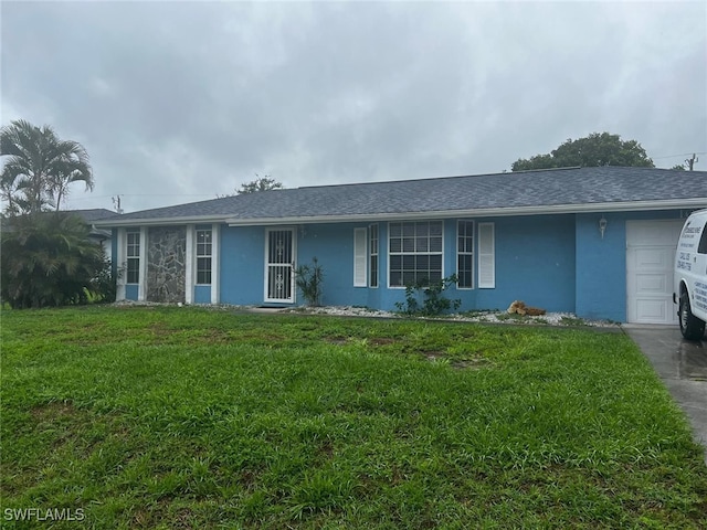 single story home with a front lawn and a garage