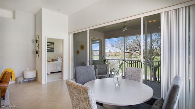 dining area with light tile patterned floors and a ceiling fan