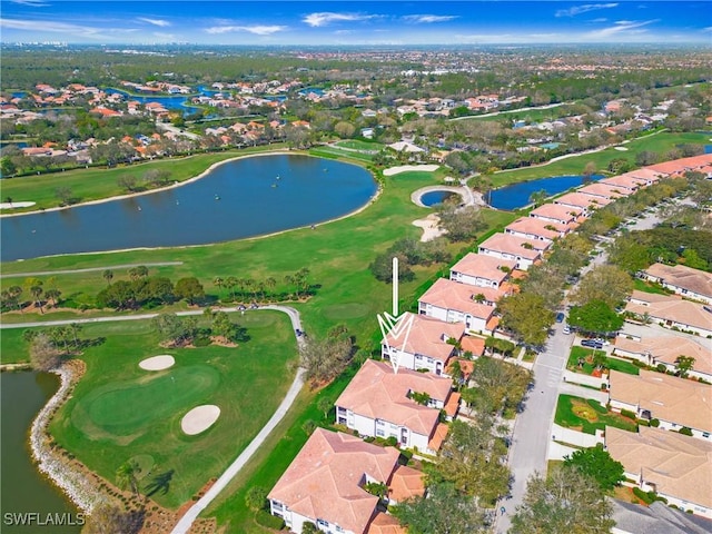 drone / aerial view with a residential view, a water view, and golf course view