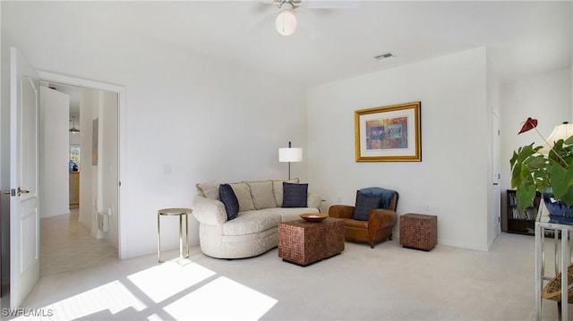 living room featuring light carpet, ceiling fan, and visible vents