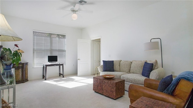 living room with light colored carpet, ceiling fan, and visible vents