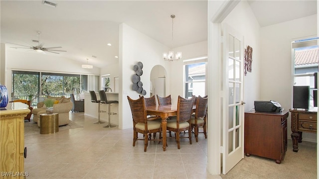 dining area featuring vaulted ceiling, visible vents, plenty of natural light, and light tile patterned floors