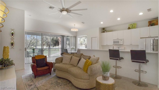 living room featuring light tile patterned floors, a ceiling fan, visible vents, and recessed lighting