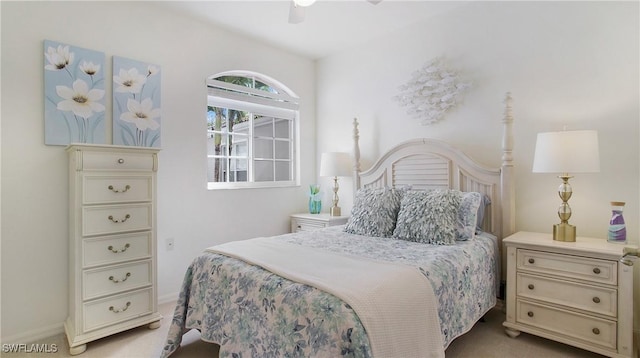 bedroom featuring light carpet and a ceiling fan