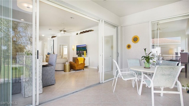 sunroom featuring ceiling fan