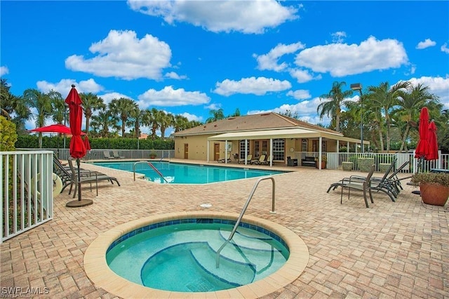 community pool with a community hot tub and fence