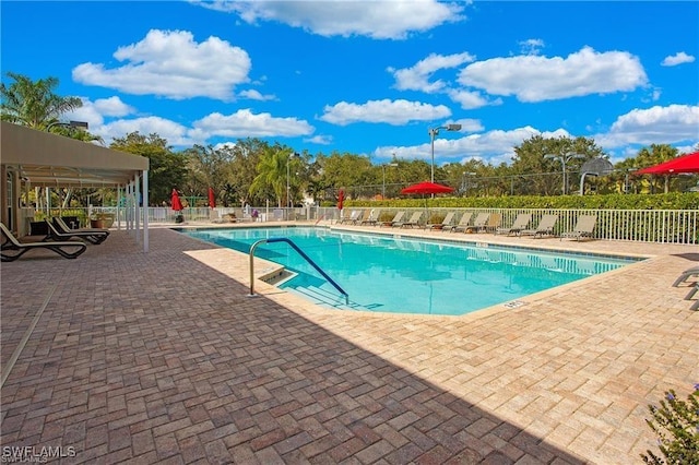 community pool featuring a patio and fence