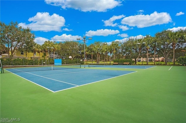 view of sport court featuring fence