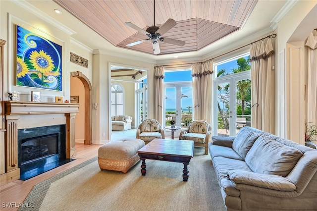 11550 Paige Ct, Captiva, FL 33924 - living area featuring wood ceiling, ornamental molding, arched walkways, and ceiling fan