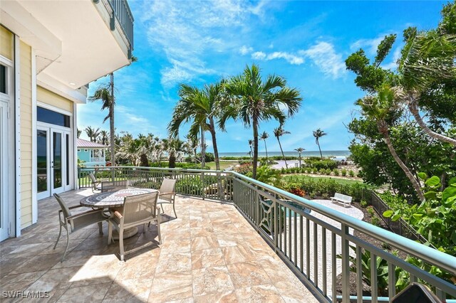 11550 Paige Ct, Captiva, FL 33924 - view of patio featuring outdoor dining space, a water view, and french doors