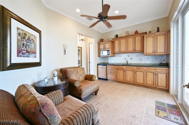11550 Paige Ct, Captiva, FL 33924 - kitchen with light tile patterned flooring, dark countertops, crown molding, and decorative backsplash
