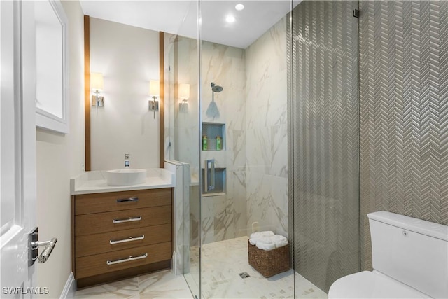 full bath with vanity, toilet, and a marble finish shower