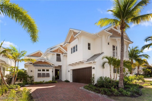 view of front of home featuring stucco siding, an attached garage, and decorative driveway