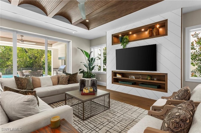 living room with lofted ceiling, wood finished floors, a wealth of natural light, and ceiling fan