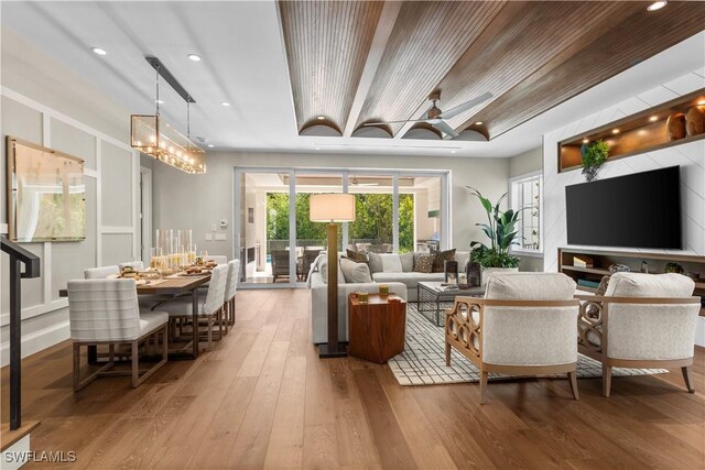 living room with recessed lighting, a notable chandelier, and hardwood / wood-style flooring