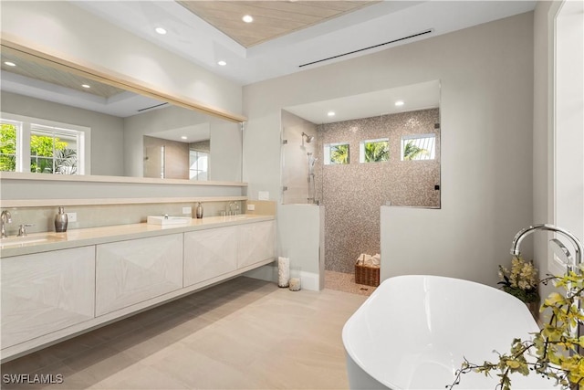 bathroom with double vanity, recessed lighting, a walk in shower, and a sink
