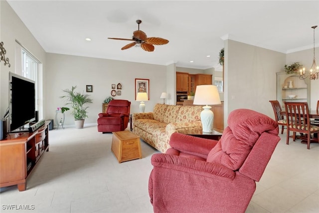 living room with ceiling fan with notable chandelier, crown molding, and recessed lighting