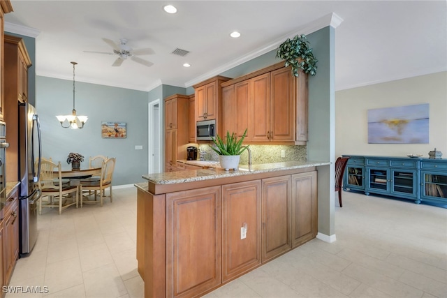 kitchen with stainless steel appliances, hanging light fixtures, brown cabinetry, and visible vents