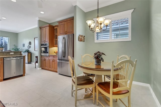 kitchen featuring stone countertops, brown cabinetry, appliances with stainless steel finishes, decorative light fixtures, and a wealth of natural light