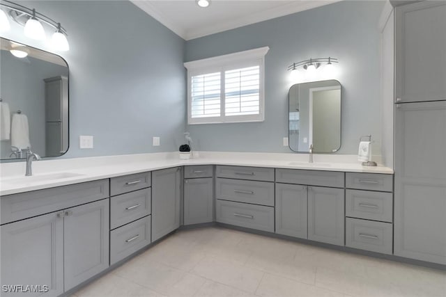 full bathroom featuring double vanity, tile patterned flooring, crown molding, and a sink