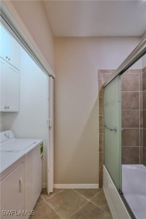 interior space featuring washing machine and clothes dryer and light tile patterned floors