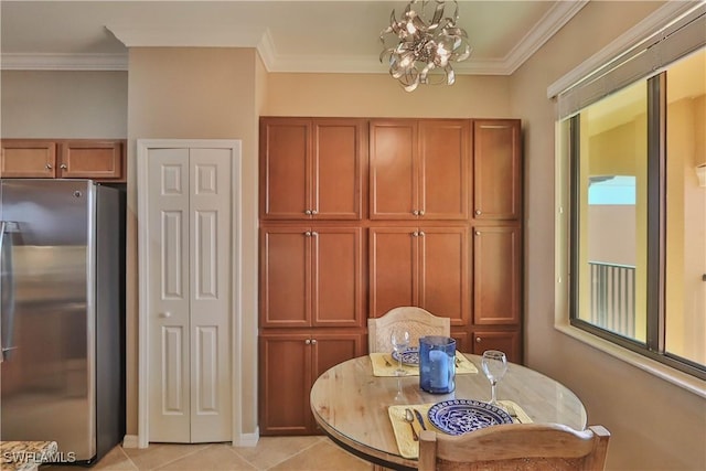 tiled dining area with a notable chandelier and ornamental molding