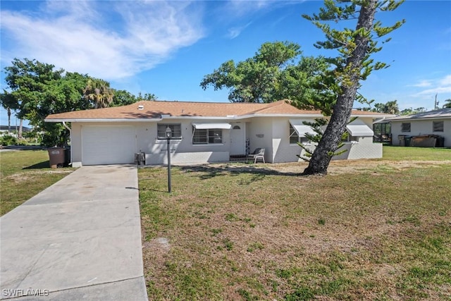 single story home featuring a front lawn and a garage