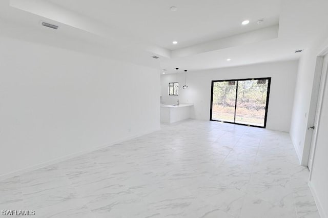 empty room featuring a raised ceiling