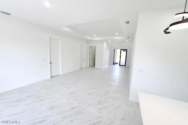 spare room with a tray ceiling