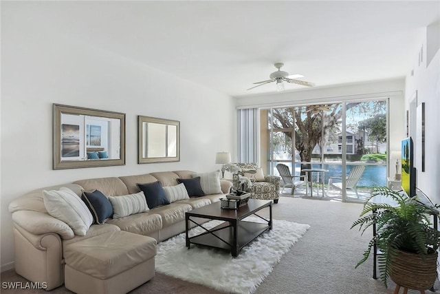 living area with carpet and ceiling fan