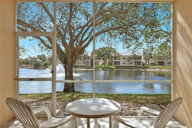 unfurnished sunroom featuring a water view