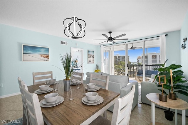 tiled dining area with ceiling fan with notable chandelier