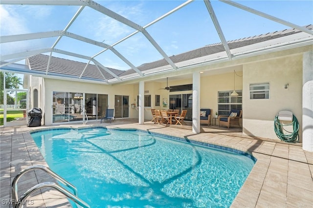 pool with a lanai, a patio area, ceiling fan, and a grill