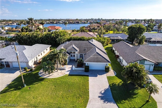 birds eye view of property featuring a water view and a residential view