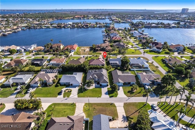 birds eye view of property with a water view and a residential view