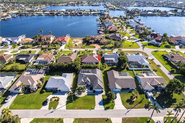 birds eye view of property featuring a residential view and a water view