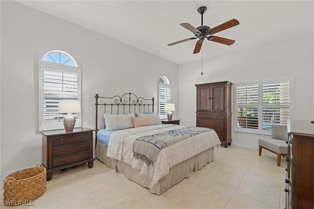 bedroom with light tile patterned floors, multiple windows, and a ceiling fan