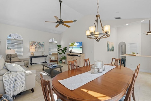 dining space featuring high vaulted ceiling, ceiling fan, visible vents, and arched walkways