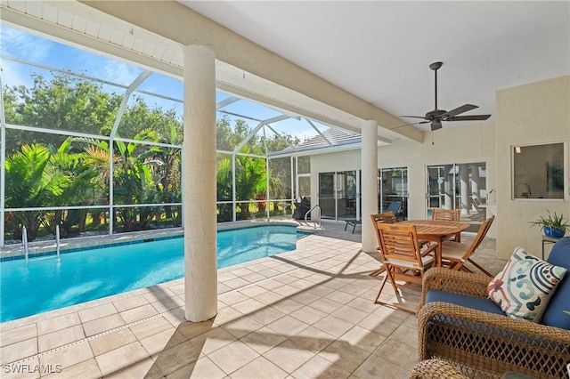 pool featuring a patio area, ceiling fan, glass enclosure, and outdoor dining area