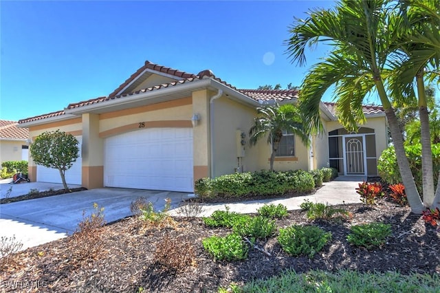 mediterranean / spanish home with a garage