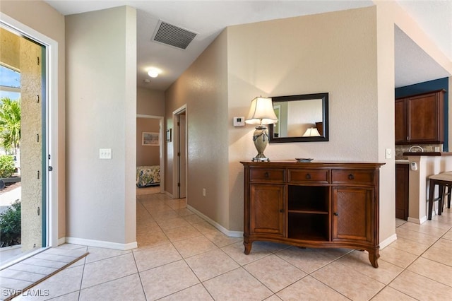 hall featuring light tile patterned flooring