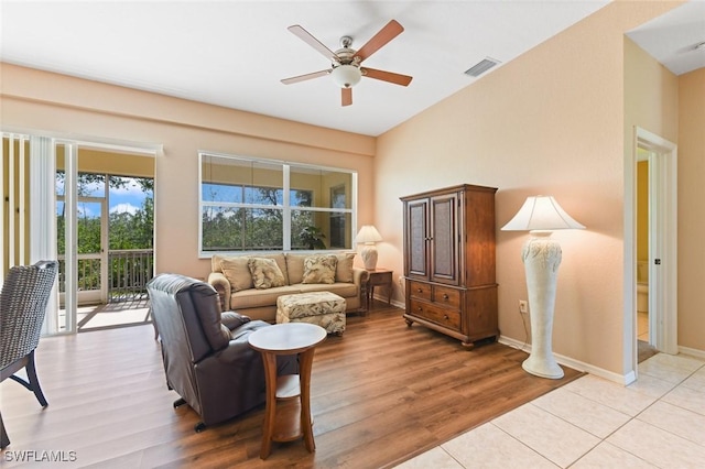 living room featuring ceiling fan and light hardwood / wood-style flooring