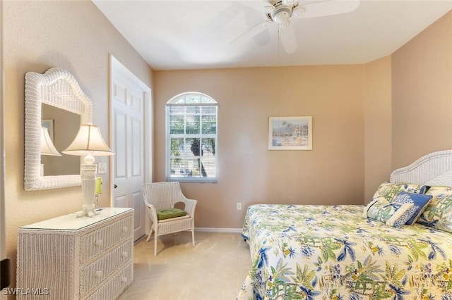 bedroom with ceiling fan and light carpet