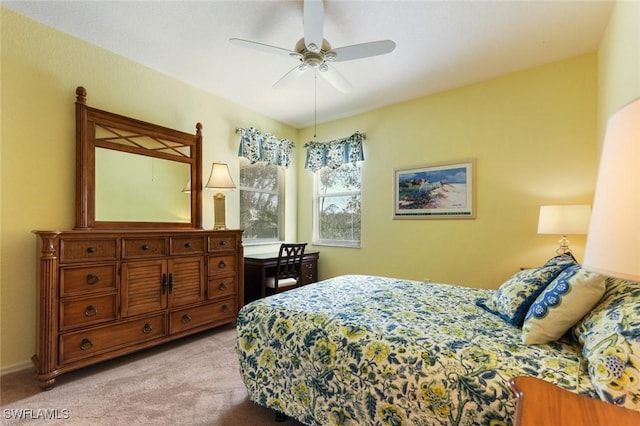 bedroom featuring light colored carpet and ceiling fan