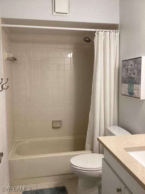 full bathroom with tile patterned floors, shower / bath combo, vanity, and toilet