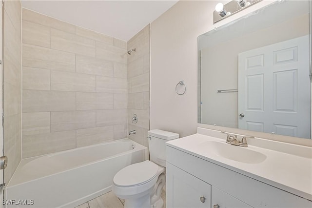 full bathroom featuring vanity, toilet, and tiled shower / bath