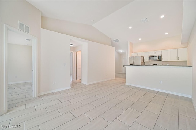 unfurnished living room with vaulted ceiling